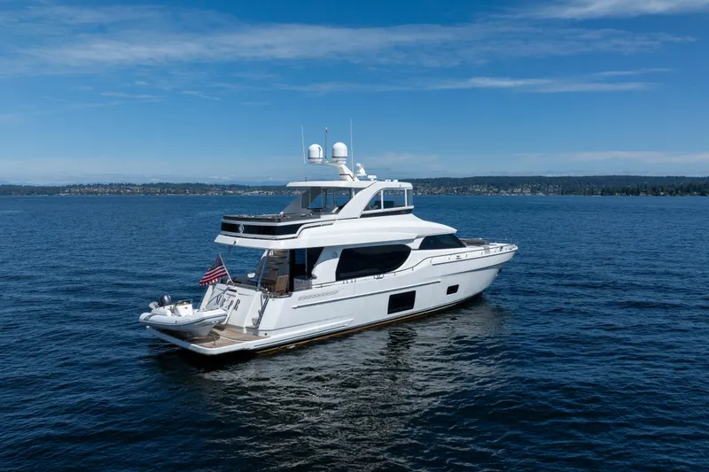 Slide: The Image of Luxury 2017 Ocean Alexander 70 E yacht cruising on open water under clear skies. - 2