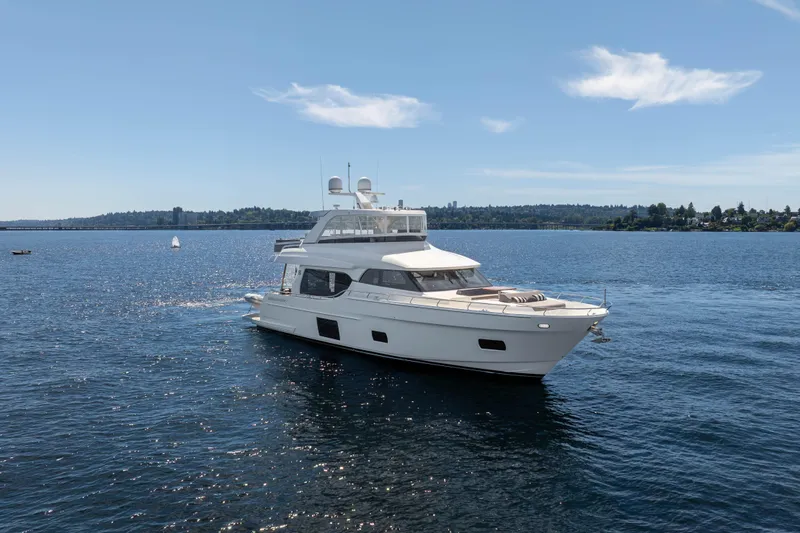 Slide: The Image of Luxury 2017 Ocean Alexander 70 E yacht cruising on a serene blue lake. - 3