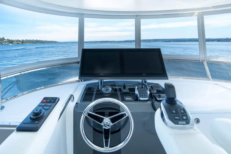 Slide: The Image of Cockpit view of 2017 Ocean Alexander 70 E yacht with steering wheel and navigation screens. - 38