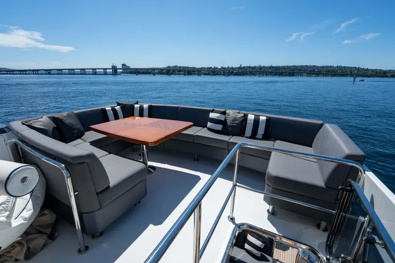 Slide: The Image of Luxurious seating area on 2017 Ocean Alexander 70 E yacht, overlooking serene waters. - 43