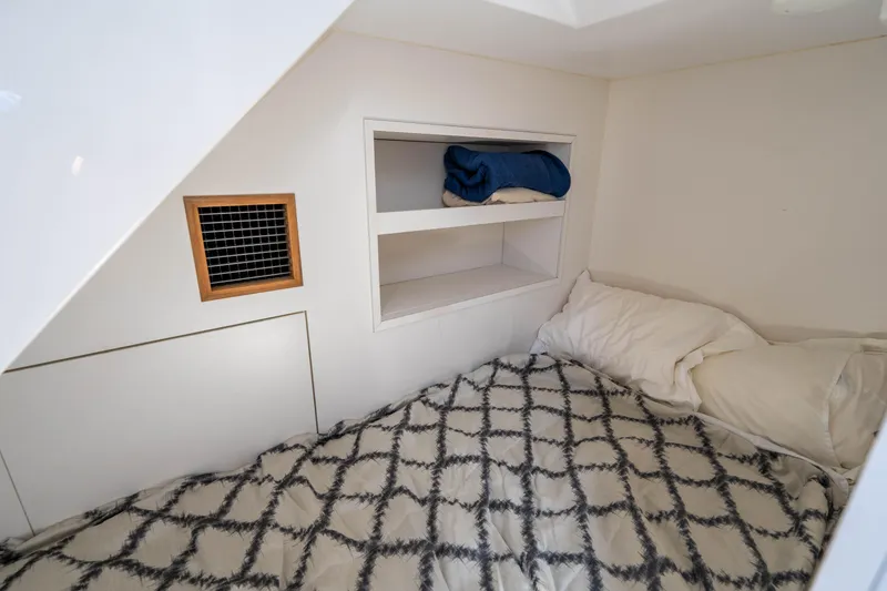 Slide: The Image of Cozy cabin interior of 2017 Ocean Alexander 70 E yacht with bed and storage shelves. - 48