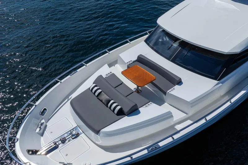 Slide: The Image of Luxurious 2017 Ocean Alexander 70 E yacht with sunbathing area and table on deck. - 6