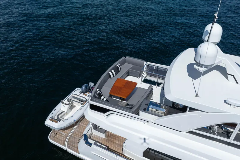 Slide: The Image of Luxurious 2017 Ocean Alexander 70 E yacht with spacious deck and tender, cruising on open water. - 8