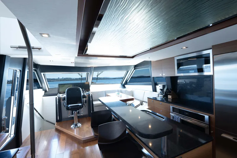 Slide: The Image of Luxurious helm of 2017 Ocean Alexander 70 E yacht with panoramic windows and modern navigation equipment. - 21