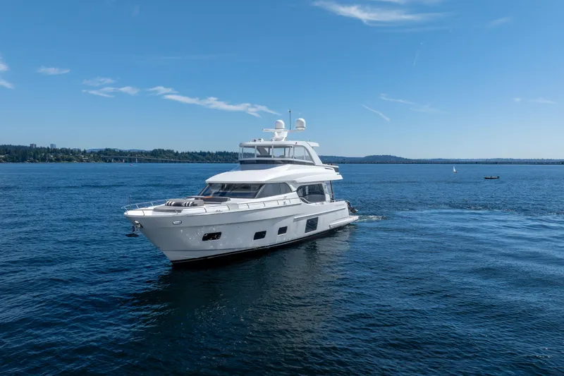 Slide: The Image of Luxury 2017 Ocean Alexander 70 E yacht cruising on a serene blue lake. - 4