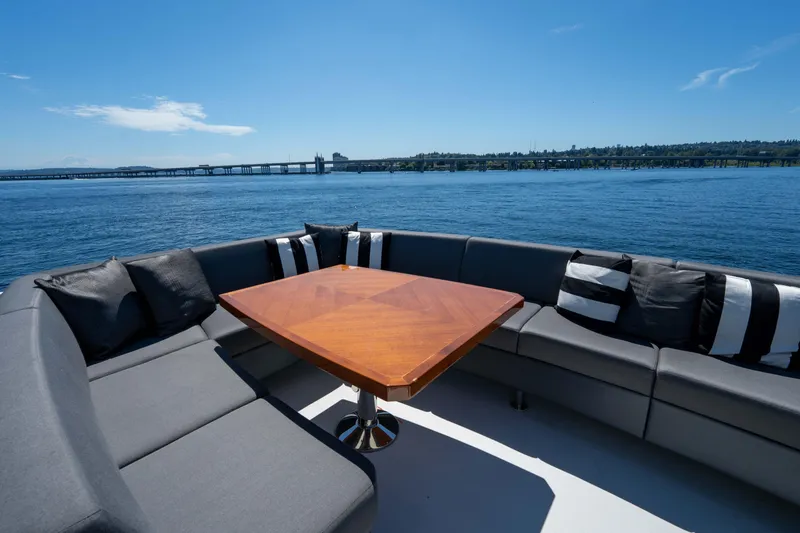 Slide: The Image of Luxurious seating area on 2017 Ocean Alexander 70 E yacht, overlooking serene waters. - 44