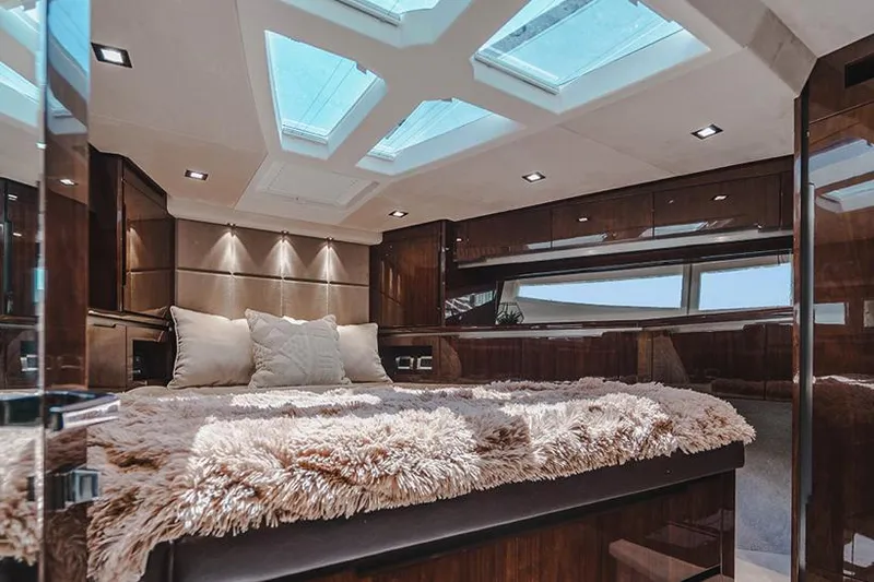 Slide: The Image of Luxurious interior of 2024 Galeon 470 Sky yacht with plush bedding and skylights. - 11
