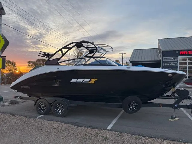 Slide: The Image of 2023 Yamaha Boats 252XE, black, on trailer, side view. - 1