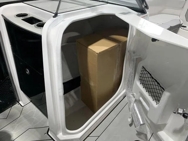 Slide: The Image of 2023 Yamaha Boats 252XE control panel with cup holder and L-Series branding. - 19