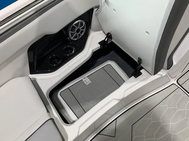 Slide: The Image of 2023 Yamaha Boats 252XE interior seating with speaker and cup holders. - 24