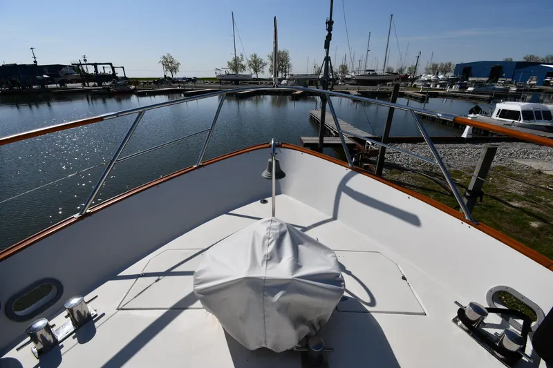 Slide: The Image of Bow view of 1986 Lowland 64 Pilot House Long Range Motor Yacht in marina. - 11