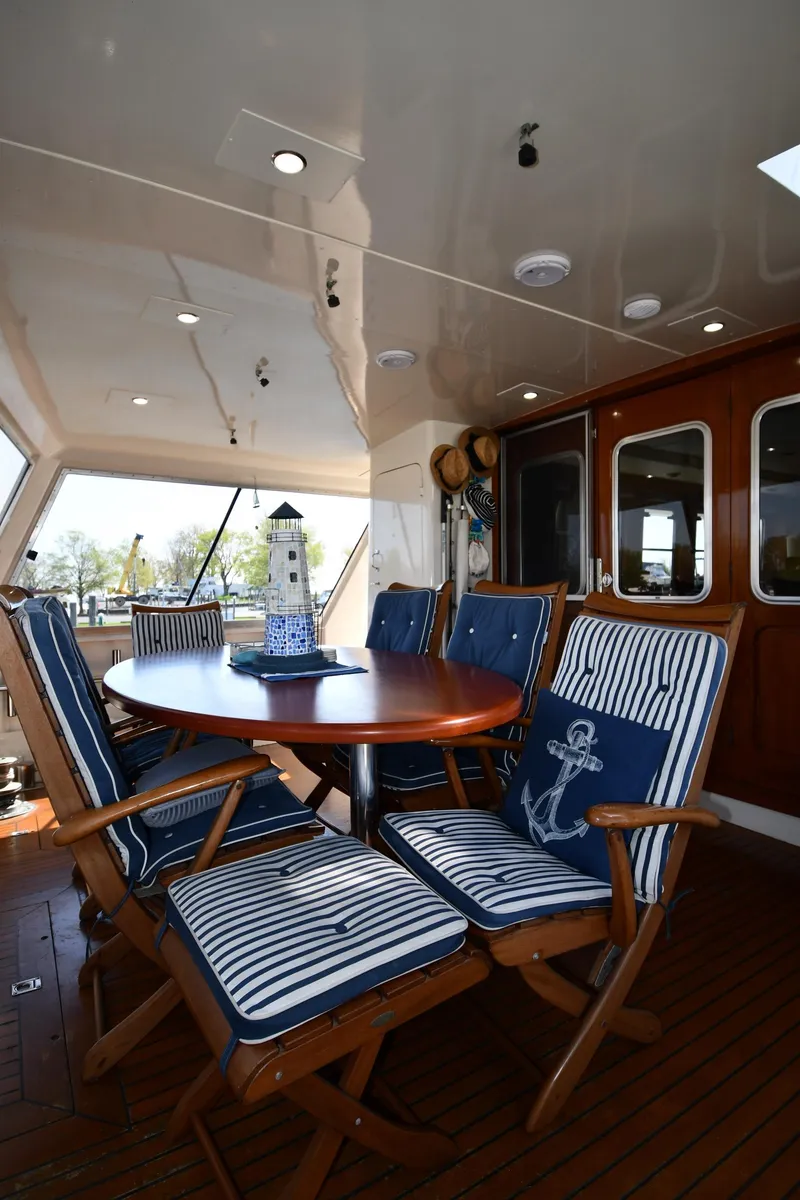 Slide: The Image of Outdoor seating area on 1986 Lowland 64 Pilot House Long Range Motor Yacht. - 20