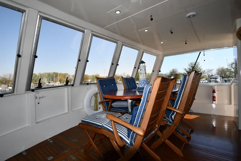 Slide: The Image of Enclosed deck seating area on 1986 Lowland 64 Pilot House Long Range Motor Yacht. - 21