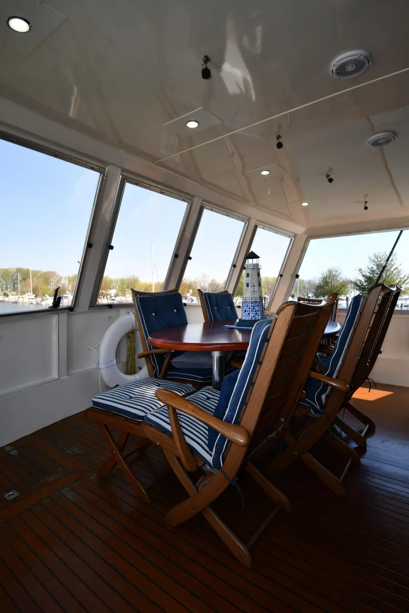 Slide: The Image of Enclosed deck seating area on 1986 Lowland 64 Pilot House Long Range Motor Yacht. - 22