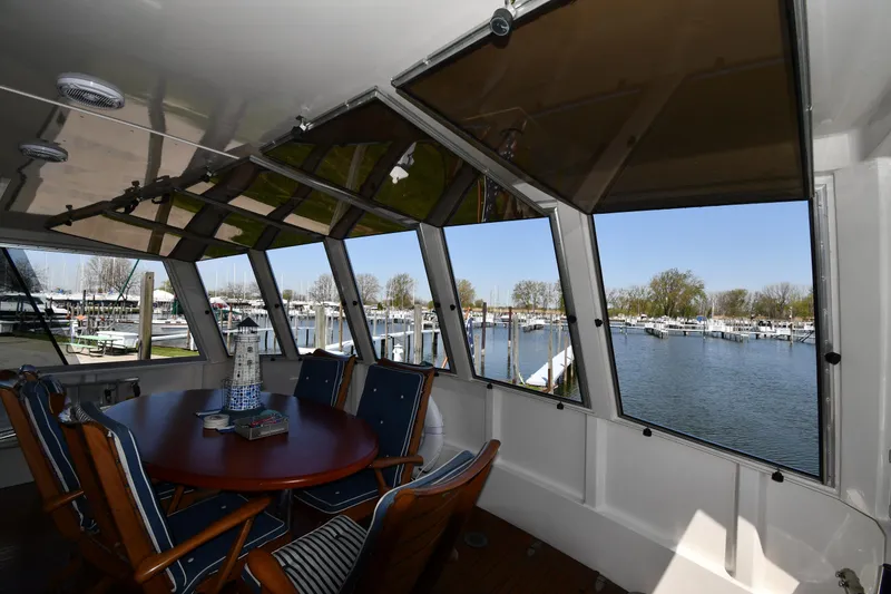 Slide: The Image of Interior view of 1986 Lowland 64 Pilot House Long Range Motor Yacht with marina backdrop. - 26