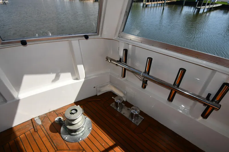 Slide: The Image of 1986 Lowland 64 Pilot House Long Range Motor Yacht deck with winch and rod holders. - 27