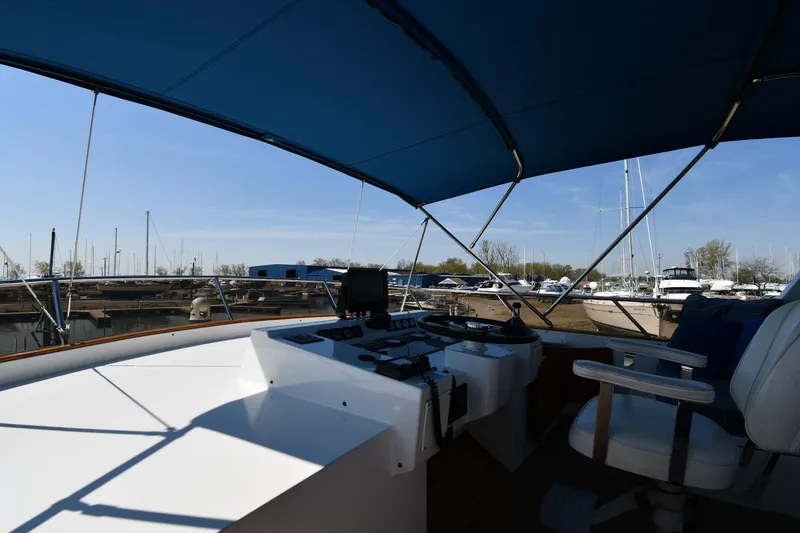 Slide: The Image of Cockpit view of 1986 Lowland 64 Pilot House Long Range Motor Yacht at marina. - 29