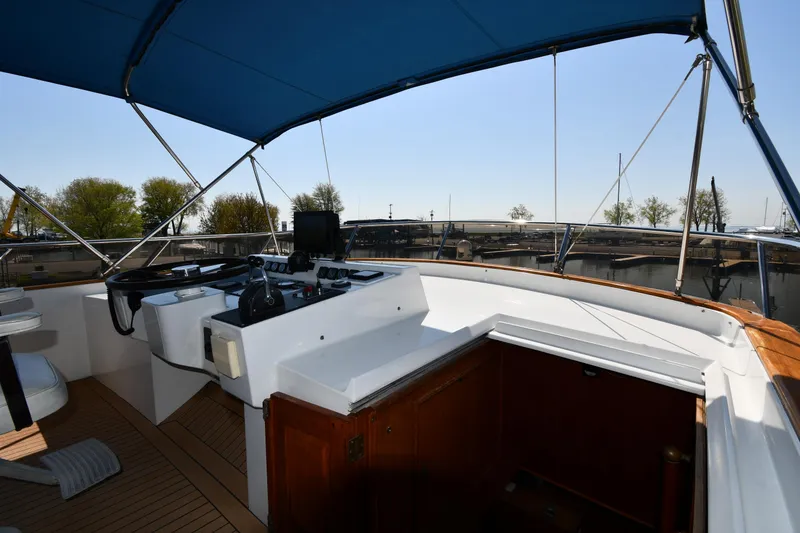 Slide: The Image of Cockpit of 1986 Lowland 64 Pilot House Long Range Motor Yacht with blue canopy. - 31