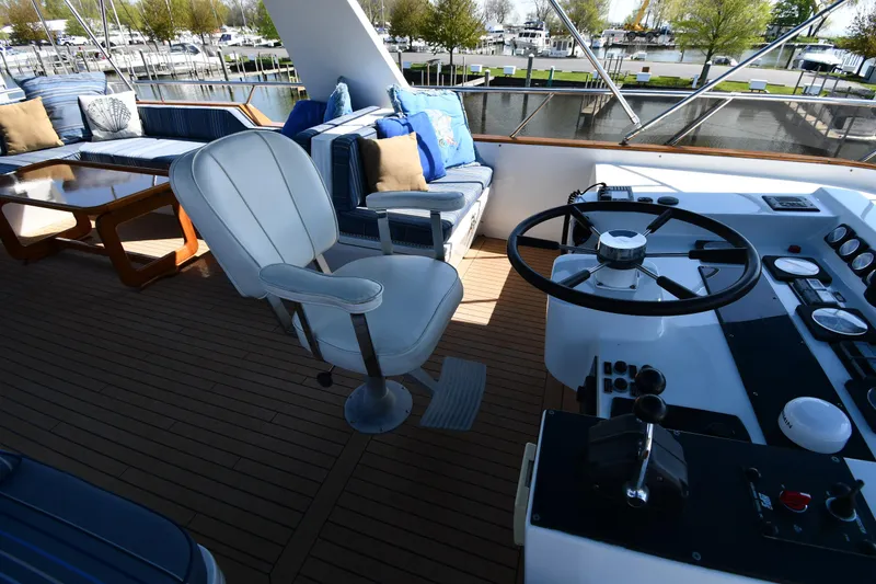 Slide: The Image of Cockpit of 1986 Lowland 64 Pilot House Long Range Motor Yacht with seating and steering wheel. - 35