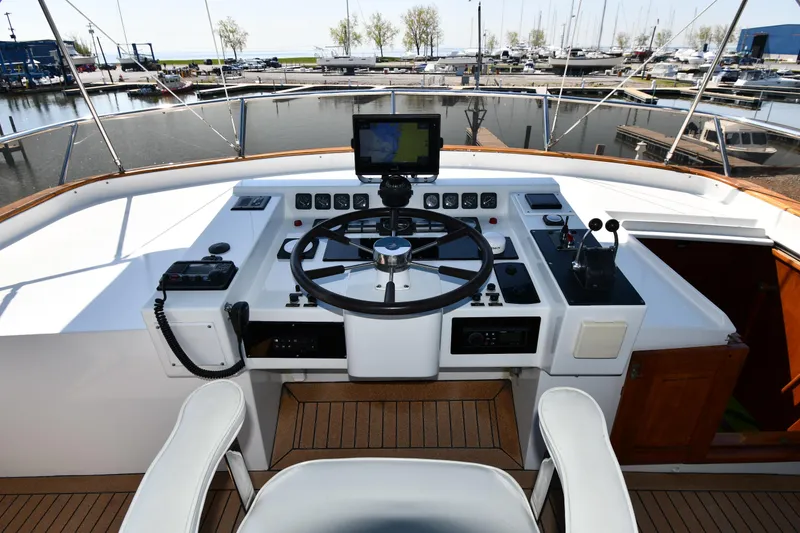 Slide: The Image of Cockpit of 1986 Lowland 64 Pilot House Long Range Motor Yacht with steering wheel and navigation equipment. - 37