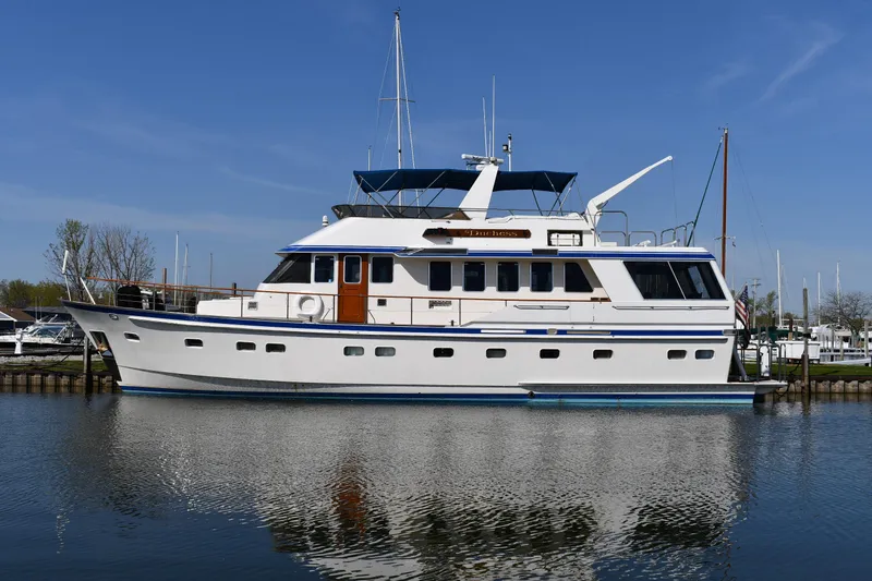 Slide: The Image of 1986 Lowland 64 Pilot House Long Range Motor Yacht docked in a marina. - 4