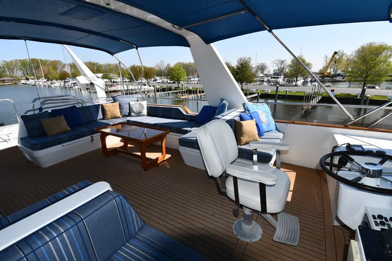 Slide: The Image of Spacious deck of 1986 Lowland 64 Pilot House Long Range Motor Yacht with seating and helm. - 44