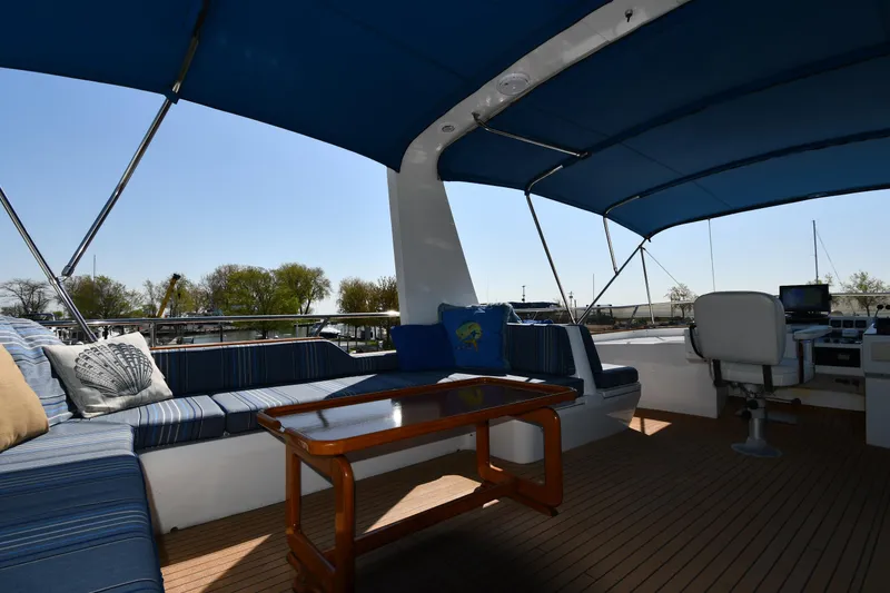 Slide: The Image of 1986 Lowland 64 Pilot House Long Range Motor Yacht deck with seating and table. - 48