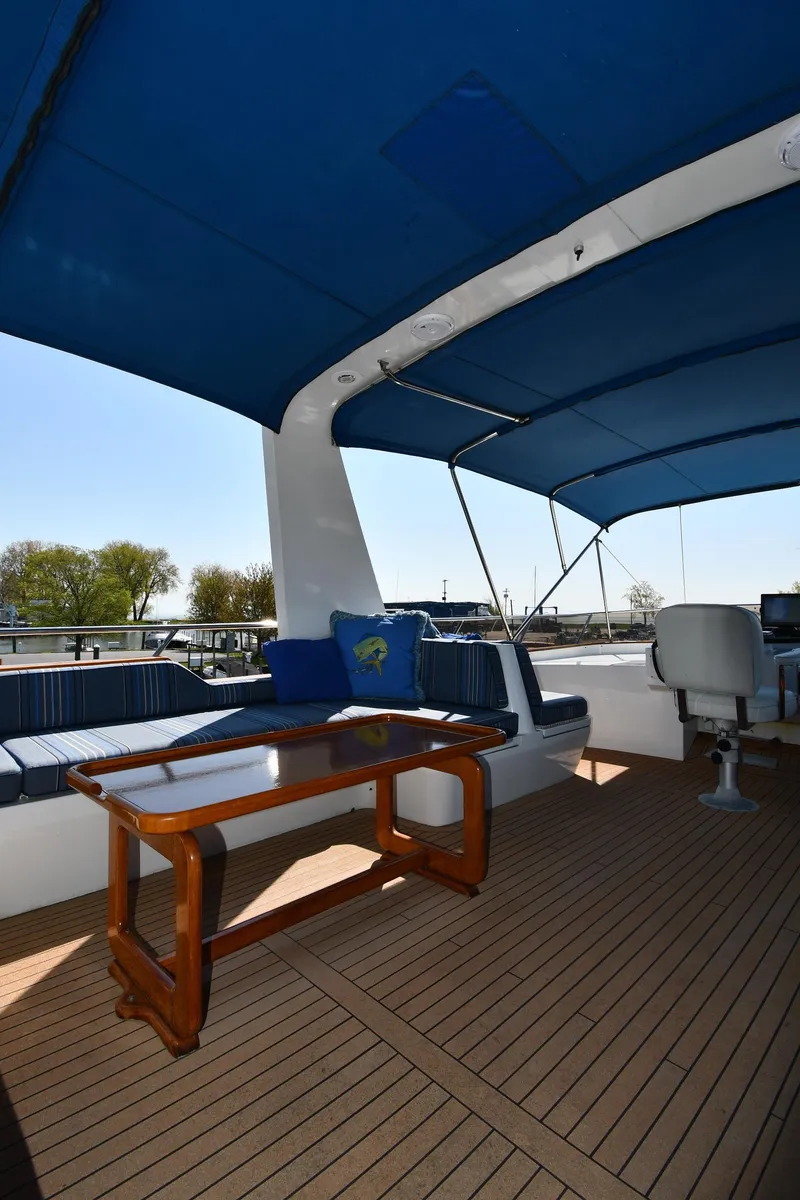 Slide: The Image of 1986 Lowland 64 Pilot House Long Range Motor Yacht deck with seating and table. - 49