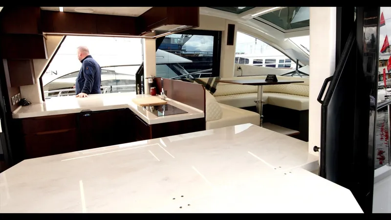 Slide: The Image of Interior of 2024 Galeon 470 Sky yacht with modern kitchen and seating area. - 16