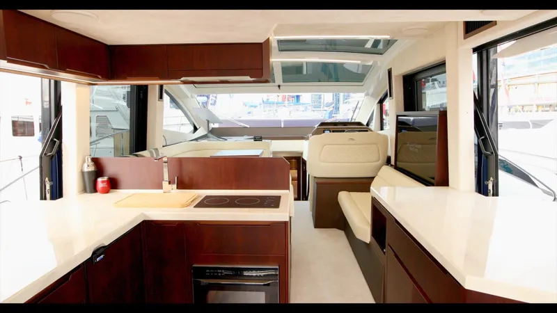Slide: The Image of Interior of 2024 Galeon 470 Sky yacht with modern kitchen and seating area. - 18