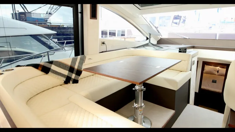 Slide: The Image of 2024 Galeon 470 Sky yacht interior with elegant seating and dining area. - 21