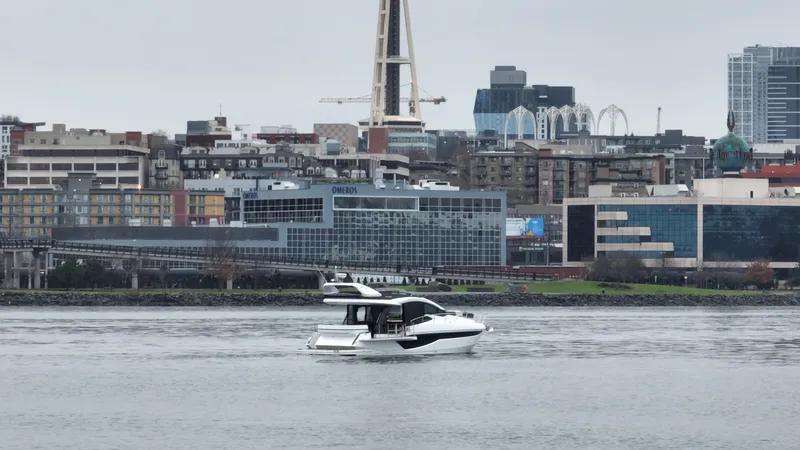 Slide: The Image of 2024 Galeon 470 Sky yacht cruising near urban skyline. - 6