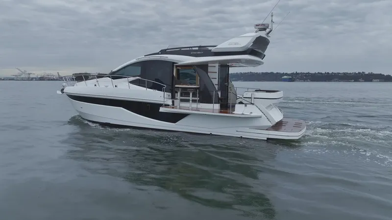 Slide: The Image of 2024 Galeon 470 Sky yacht cruising on calm waters under cloudy skies. - 8