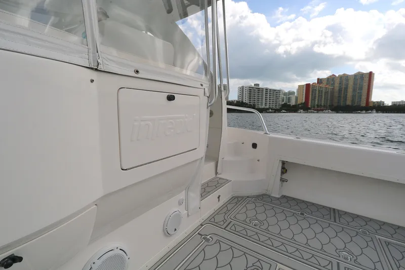 Slide: The Image of 2012 Intrepid 475 Sport Yacht deck with city skyline in background. - 15