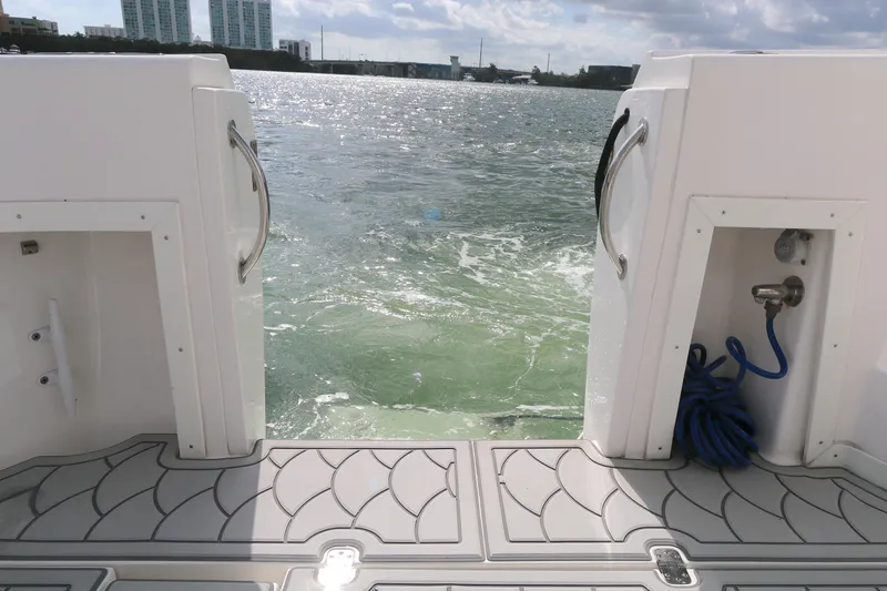 Slide: The Image of Stern view of 2012 Intrepid 475 Sport Yacht on water, featuring deck and ocean backdrop. - 17