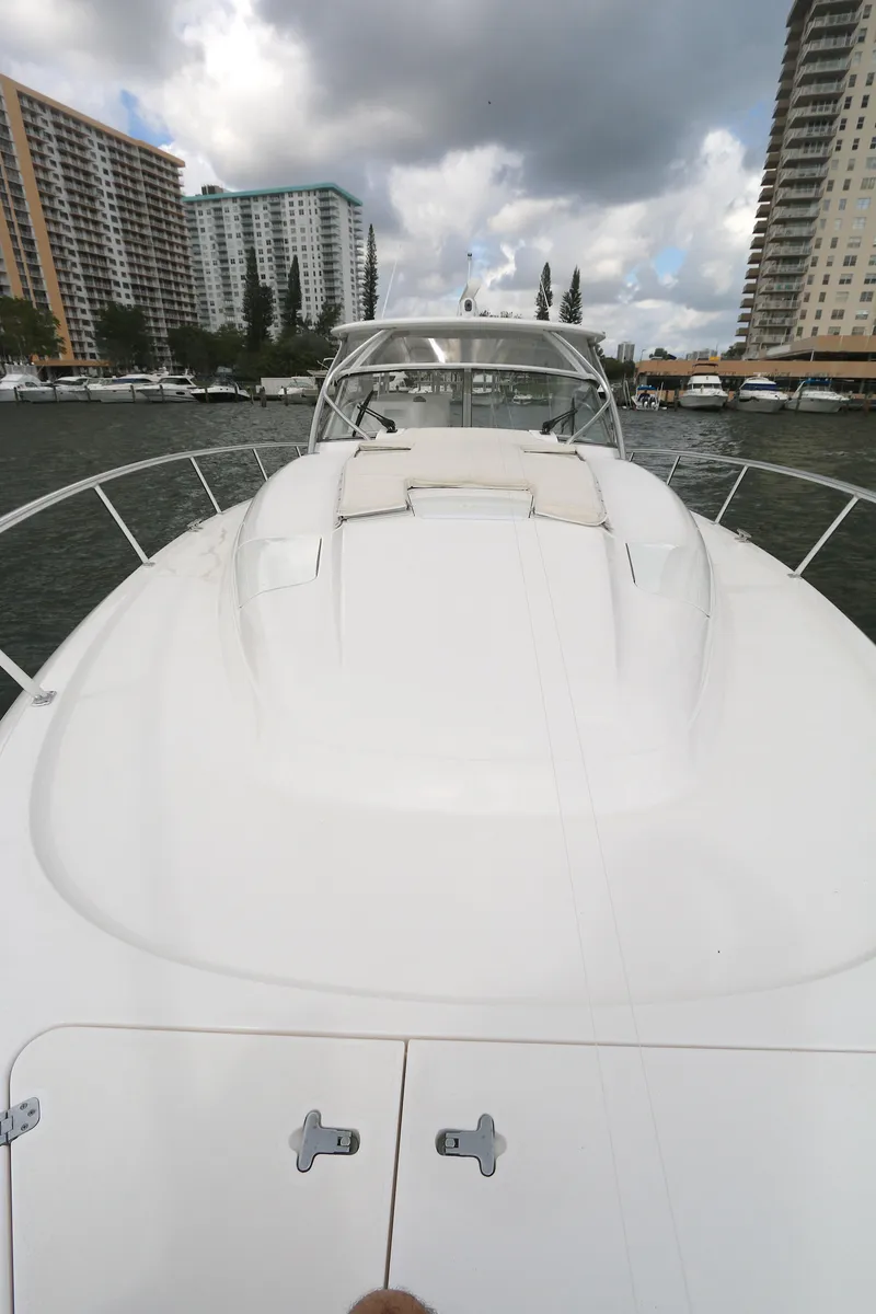 Slide: The Image of 2012 Intrepid 475 Sport Yacht on water, city skyline in background. - 18