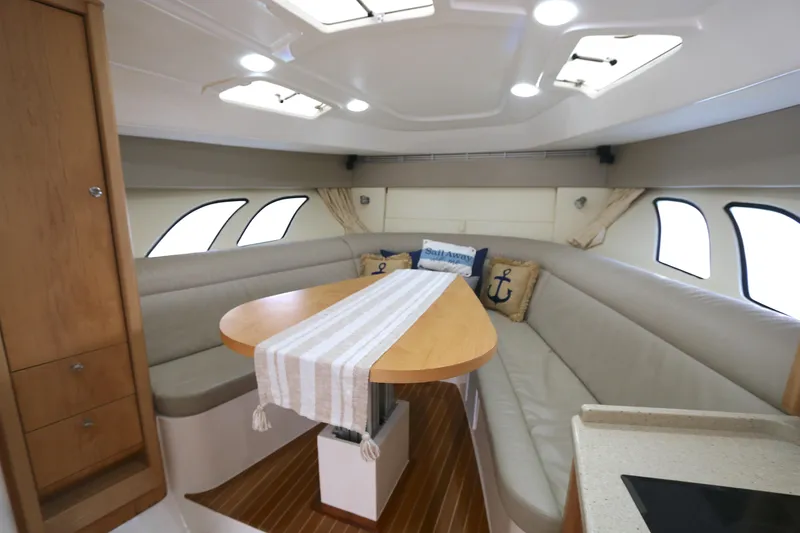 Slide: The Image of 2012 Intrepid 475 Sport Yacht interior with elegant seating and dining area. - 2