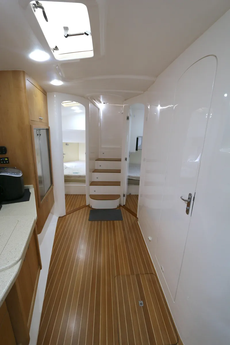Slide: The Image of 2012 Intrepid 475 Sport Yacht interior with wooden flooring and modern design. - 3