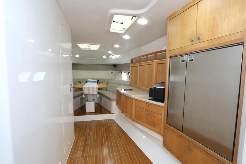 Slide: The Image of Interior of 2012 Intrepid 475 Sport Yacht with wood flooring and modern cabinetry. - 9