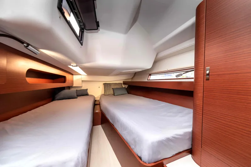 Slide: The Image of 2026 Dehler 46 yacht sailing at sunset with crew onboard. - 39