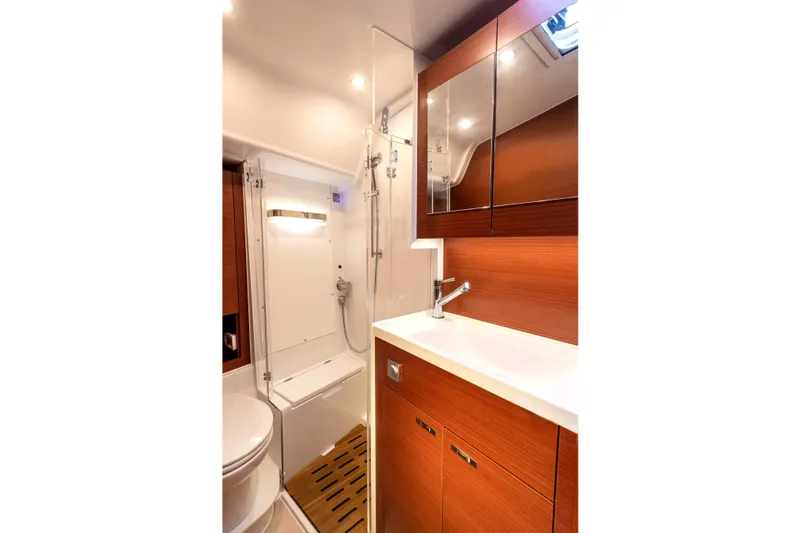 Slide: The Image of 2026 Dehler 46 yacht sailing with three people on deck, enjoying the ocean view. - 40