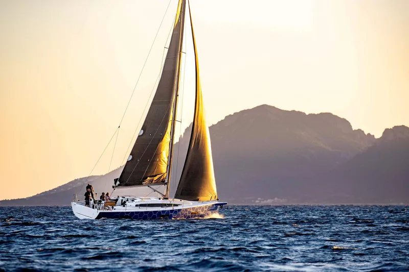 Slide: The Image of 2026 Dehler 46 yacht sailing on open sea with vibrant blue hull. - 43