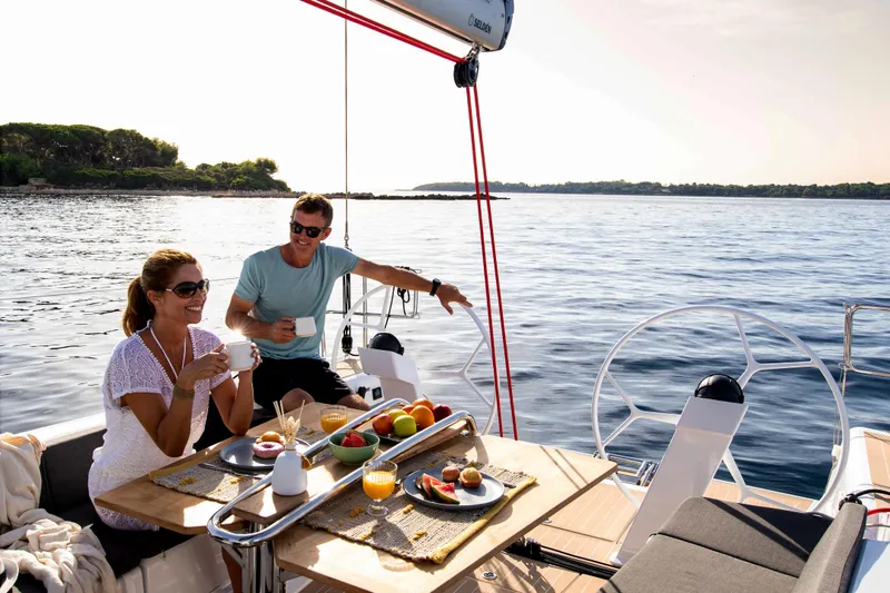 Slide: The Image of 2026 Dehler 46 yacht sailing on water, showcasing sleek blue hull design. - 44