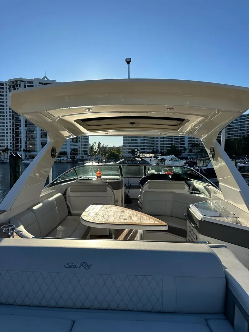 Slide: The Image of 2021 Sea Ray SLX 310 OB luxury boat with spacious seating and modern design. - 11