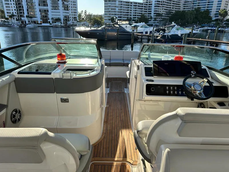 Slide: The Image of 2021 Sea Ray SLX 310 OB boat interior with waterfront view. - 13