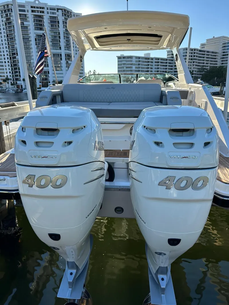 Slide: The Image of 2021 Sea Ray SLX 310 OB with twin 400 horsepower outboard engines docked at marina. - 6