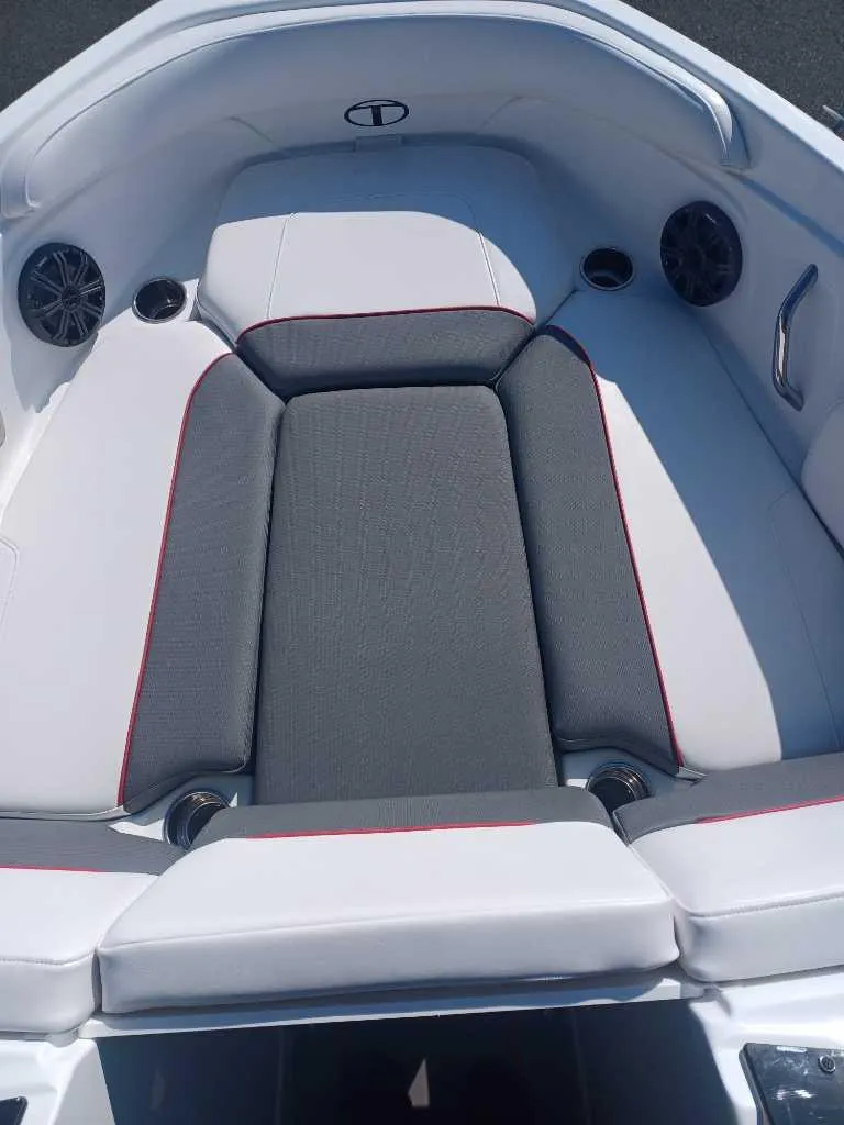 Slide: The Image of 2024 Tahoe 210 S Limited boat interior with cushioned seating and built-in speakers. - 3