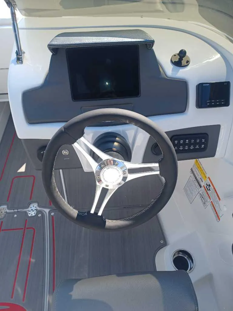 Slide: The Image of Steering console of 2024 Tahoe 210 S Limited boat with modern controls and touchscreen display. - 4