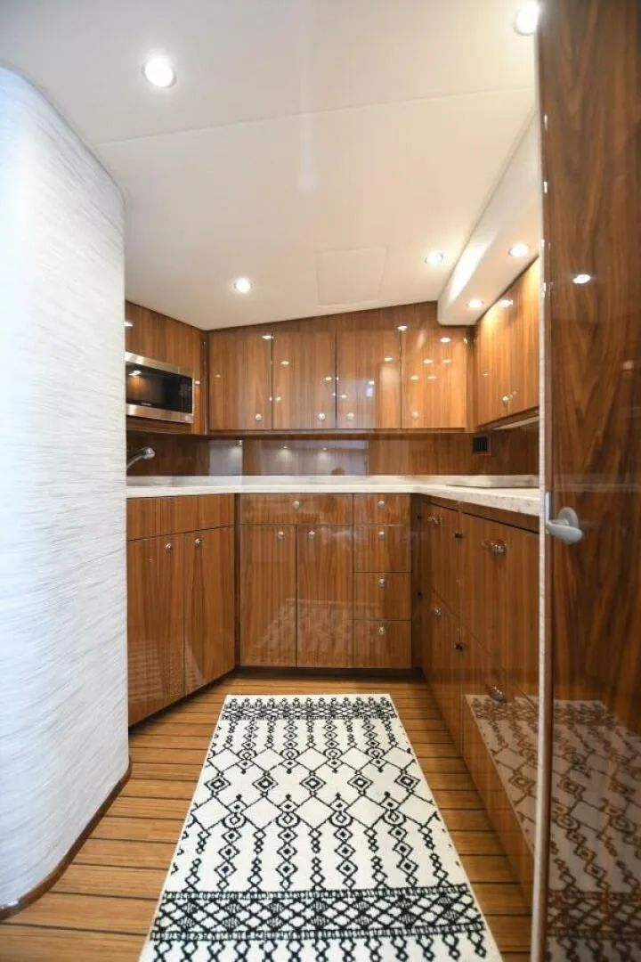 Slide: The Image of Luxurious interior of 2022 Viking 44 Sport Coupe yacht with sleek wood cabinetry and modern design. - 16