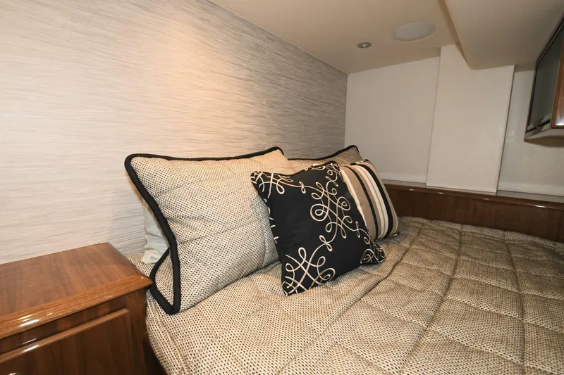 Slide: The Image of Luxurious cabin interior of 2022 Viking 44 Sport Coupe with elegant bedding and cushions. - 20